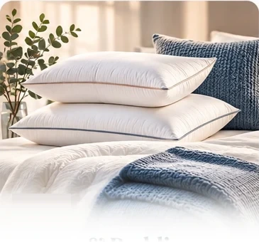 Stack of white pillows and soft bedding on a bed